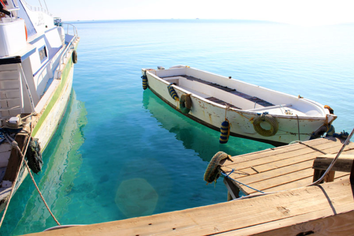 Boot im glasklaren Roten Meer vor Orange Bay